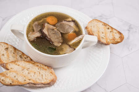 Close-up of soup with dried porcini mushrooms. Dish of Russian cuisineの写真素材