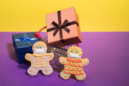A family of gingerbread men on a shopping trip during the coronovirus pandemic. The concept of...