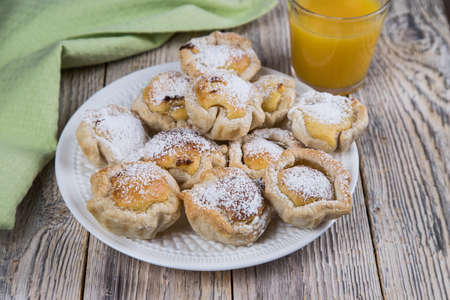 Homemade Portuguese dessert with egg cream and orange juice on a light wooden background.