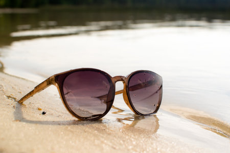 Sunglasses in the sand on the beach, sunny beach, outdoor recreation.の写真素材