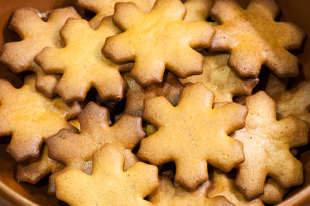Closeup with snowflakes of gingerbread cookies for Christmas Eve