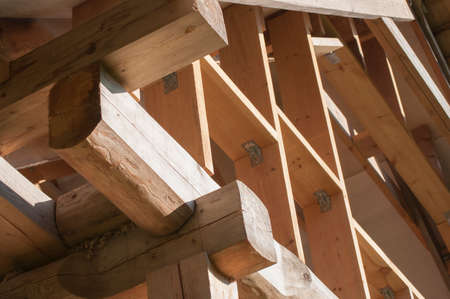 Wall frame construction on log house attic