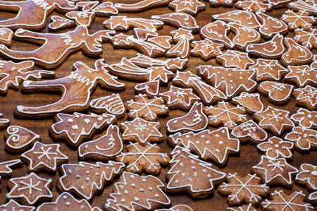 Homemade gingerbread biscuits in shapes of stars, snowflakes, birds, elks and Christmas trees for Christmas holidaysの写真素材