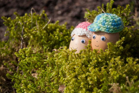 Couple of cute eggs with face for Easter decoration in spring sunlight