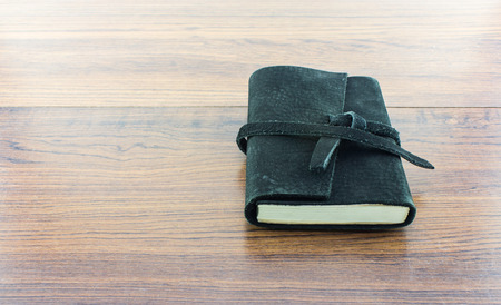 Black Leather notebooks on woodの写真素材