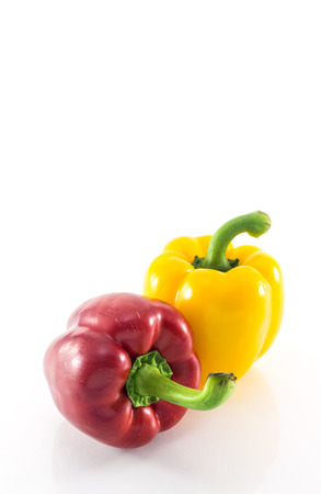 Red and yellow peppers solated on whiteの写真素材