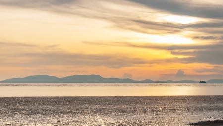 Cloudy orange sunset over seaの写真素材