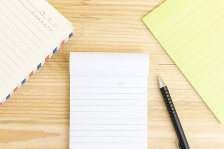 Blank open notebook with black pencil on wood table,Business template mock up for adding your text
