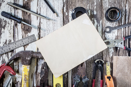 Organized copyspace white blank sheet of paper and tools on wooden boardの写真素材