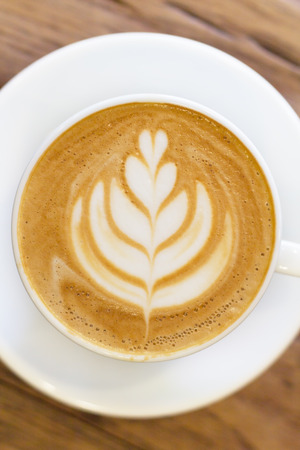 Cup of coffee latte art on wood table soft focusの写真素材