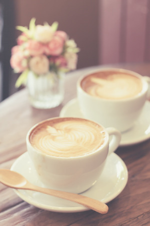 Cup of coffee latte art on wood table soft focusの写真素材
