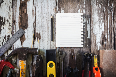 Organized copyspace white blank sheet of paper and tools on wooden boardの写真素材