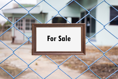 Signboard with text Home For Sale in Front of Houseの写真素材