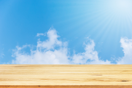 Wood table top on summer blue sky background - can be used for display or montage your productsの写真素材