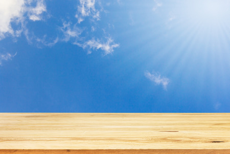Wood table top on summer blue sky background - can be used for display or montage your productsの写真素材