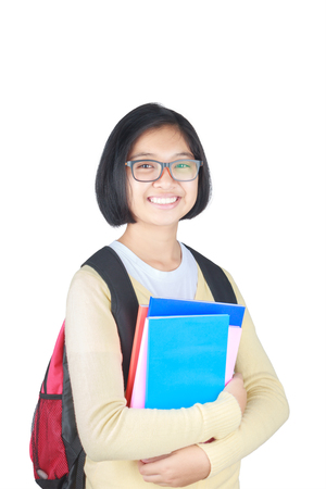 Asian Beautiful student girl with backpack and books, isolated on white backgroundの写真素材