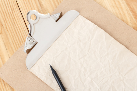 Close up crumpled paperand clip board with metal clipの写真素材