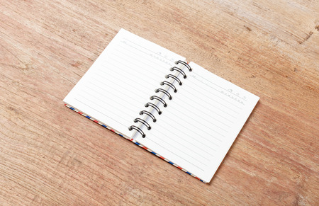 Blank open notebook on wood table,Business template mock up for adding your text