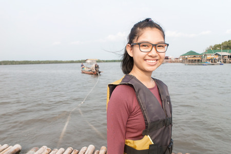 Asian girl wearing a life jacketの写真素材