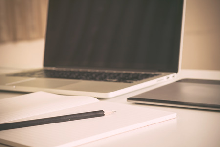 Close-up of comfortable working place with laptop, vintage effect style, selective focusの写真素材