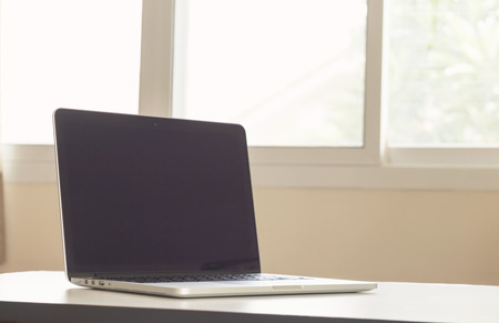 Laptop on office desk - vintage effect style picturesの写真素材