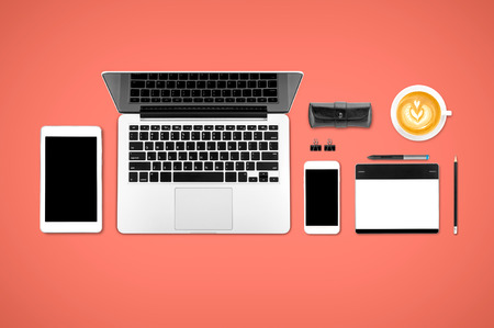 Top view laptop computer with mobile phone, cop of coffee, tablet, pencil and graphic tablet on office desk table.Business template mock up for adding your text.の写真素材