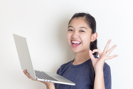 Happy Young Beautiful Woman Using Laptopの写真素材