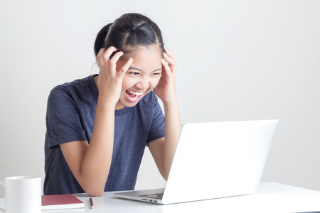 Portrait of tired Young Beautiful Woman Using Laptop at the officeの写真素材