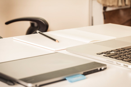 Close-up of comfortable working place with laptop, vintage effect style, selective focusの写真素材