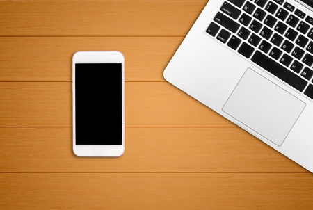 Laptop and smart phone on office desk