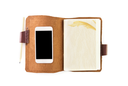 Open Notebook and smart phone isolated on white backgroundの写真素材