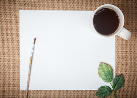 Blank white paper with coffee cup on a wooden deskの写真素材