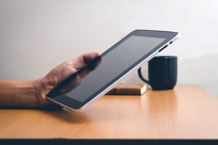 Man with modern mobile phone in hands touching on a blank screen.の写真素材