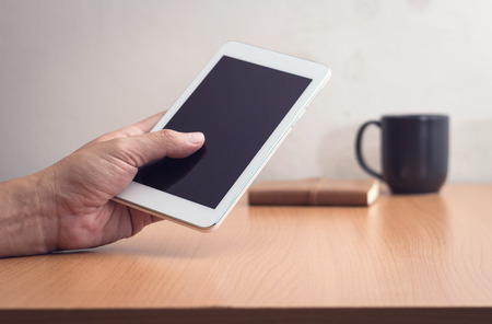 Woman with modern mobile phone in hands touching on a blank screen.
