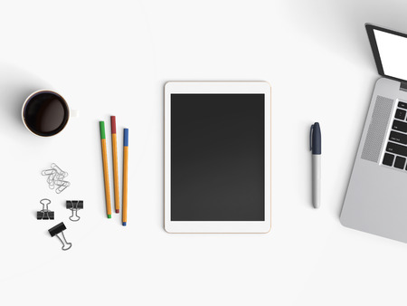 Modern office desk workplace with notebook, tablet or smartphone, pen and coffee cup copy space on...