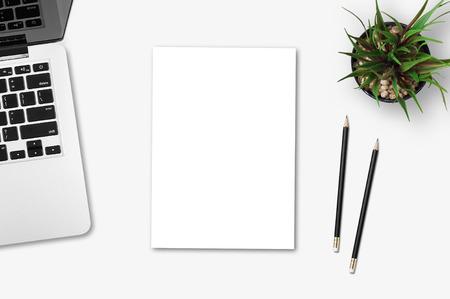Modern workplace with notebook, blank paper, pencil and little tree copy space on gray background. Top view. Flat lay style.の写真素材