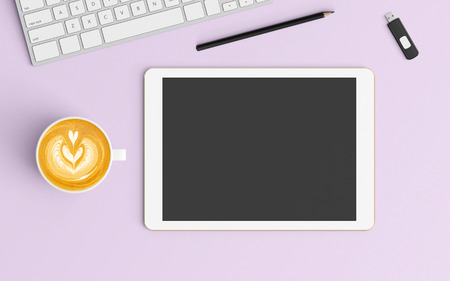 Modern office desk workplace with keyboard, coffee cup, pencil and tablet  copy space on color background. Top view. Flat lay style.の写真素材