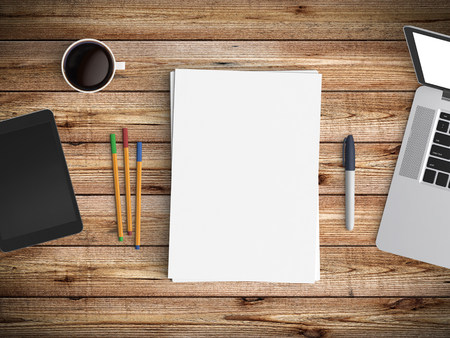 Modern office desk workplace with notebook, tablet, coffee cup, pen and blank paper copy space on wood table background. Top view. Flat lay style.の写真素材