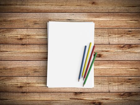Minimal office desk workplace with blank paper and pencil copy space on wood table background. Top...