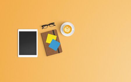 Modern workspace with coffee cup, notebook and tablet copy space on orange color background. Top view. Flat lay style.の写真素材