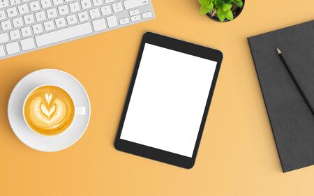 Modern workspace with coffee cup, notebook, keyboard and smartphone copy space on orange color background. Top view. Flat lay style.の写真素材