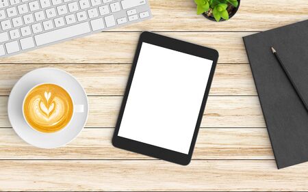 Modern workspace with coffee cup, notebook, tablet or smartphone and keyboard copy space on wood background. Top view. Flat lay style.の写真素材