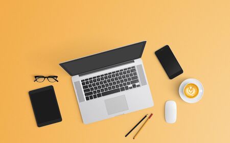Modern workspace with coffee cup, notebook, smartphone and laptop copy space on orange color background. Top view. Flat lay style.の写真素材