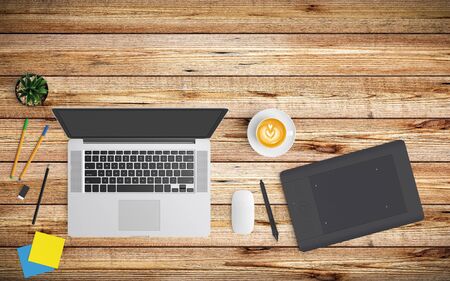 Modern workspace with coffee cup, paper, notebook, tablet or smartphone and laptop copy space on wood background. Top view. Flat lay style.の写真素材