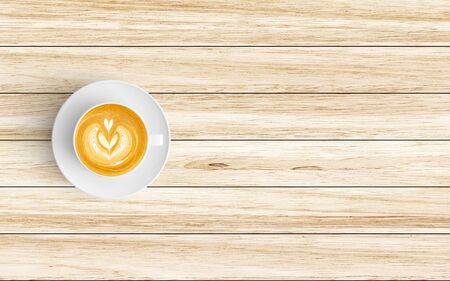 Modern workspace with coffee cup copy space on wood background. Top view. Flat lay style.の写真素材
