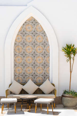 Arabian style terrace exterior with sofas, tables, stools and pillowsの写真素材