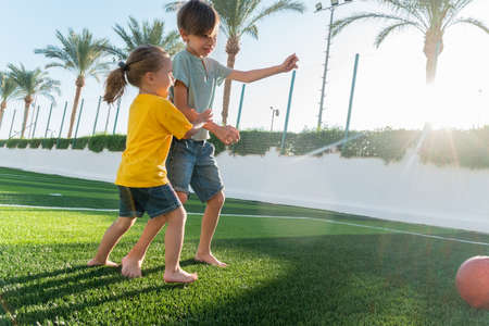 Girl and boy fighting about the ball.の写真素材
