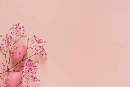 Easter composition with pink eggs and branch of flowers on pink backgroundの写真素材