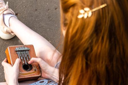 Female hands holding kalimba and playing music