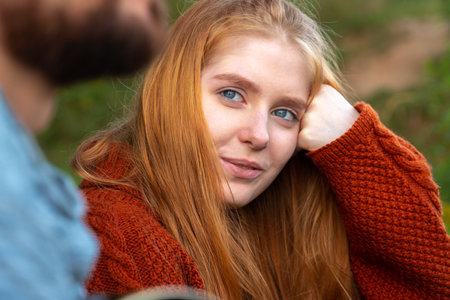 Portrait of charming young blonde woman looking at her boyfriend with love in summer day. One shot...